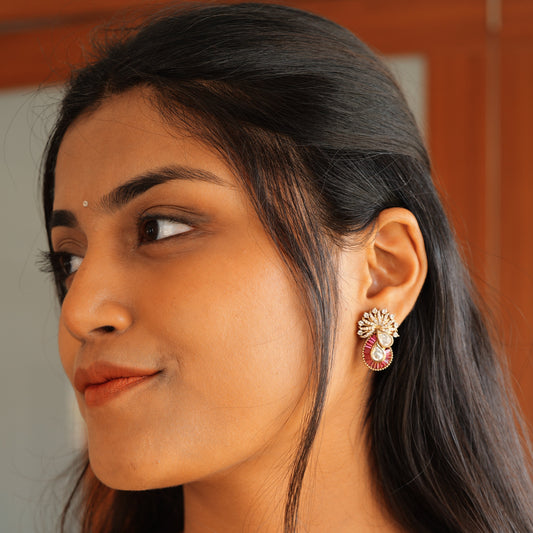 Kundan encrusted  peacock earrings with ruby baguettes.